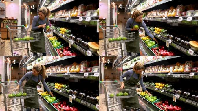 美丽的女售货员在超市的冷藏农产品区给牛油果进货