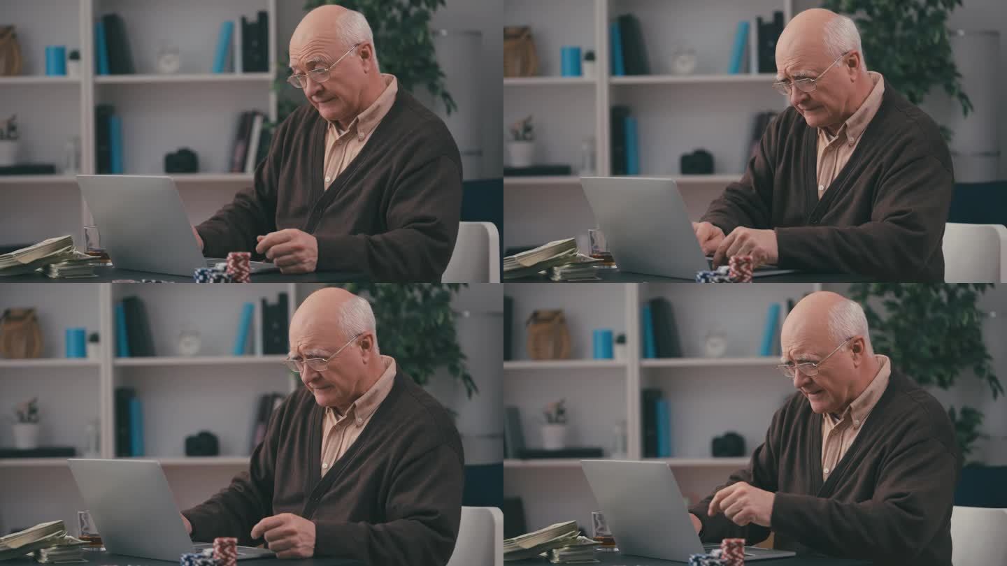 老人在家里用笔记本电脑玩在线扑克，赌博