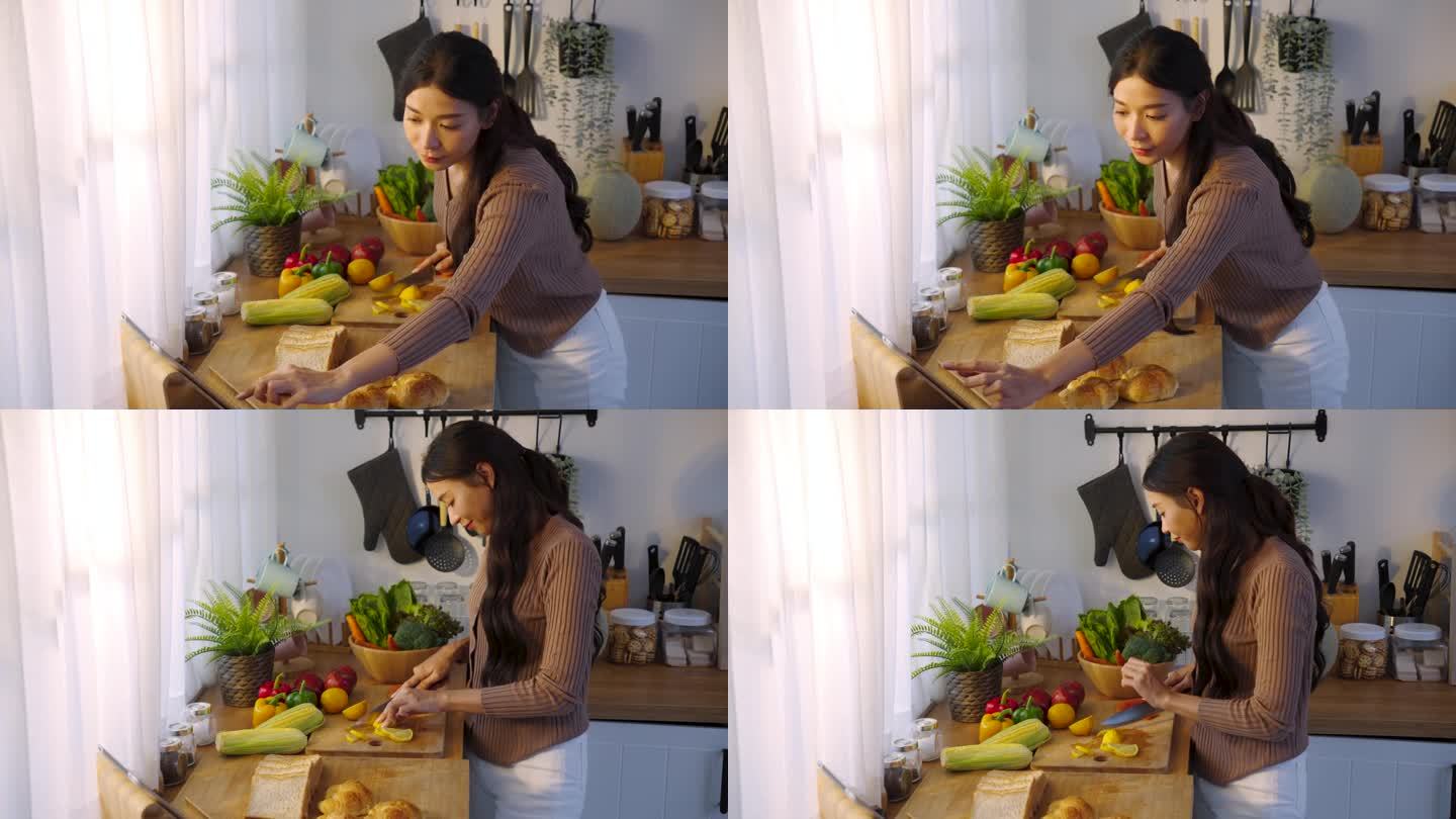 女人在平板电脑上通过视频教程练习晚餐。