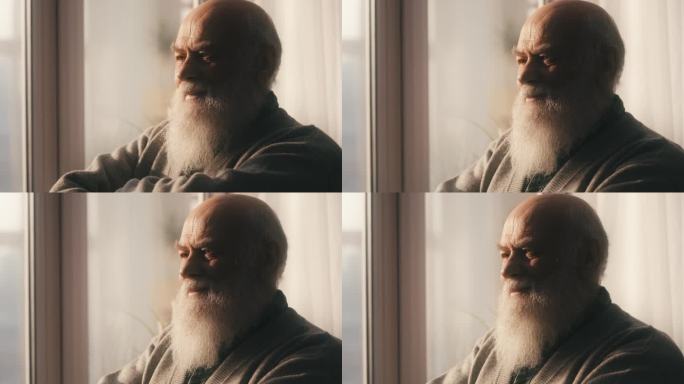 快乐的老人留着胡子站在窗前，老了，美好的回忆