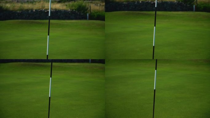 高尔夫球旗在推杆洞中的特写镜头。
