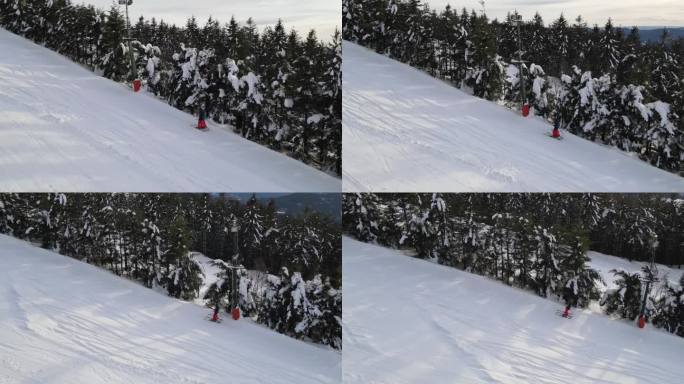 两个滑雪者被t型杠拉上山