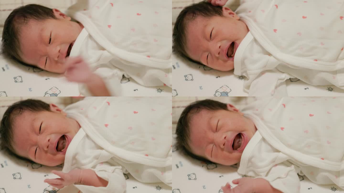 刚出生的婴儿在床上哭
