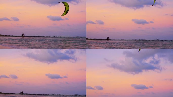 人们在海边放风筝。令人愉悦的史诗般的粉色晚霞和在空中盘旋的风筝会让夜晚变得愉快和放松。概念享受一个神