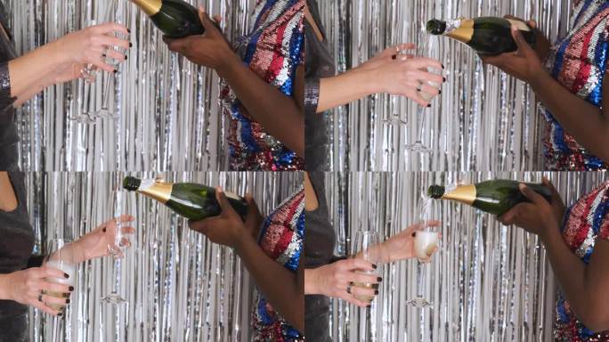 素不相识的女人从酒瓶里端出香槟酒杯庆祝新年。