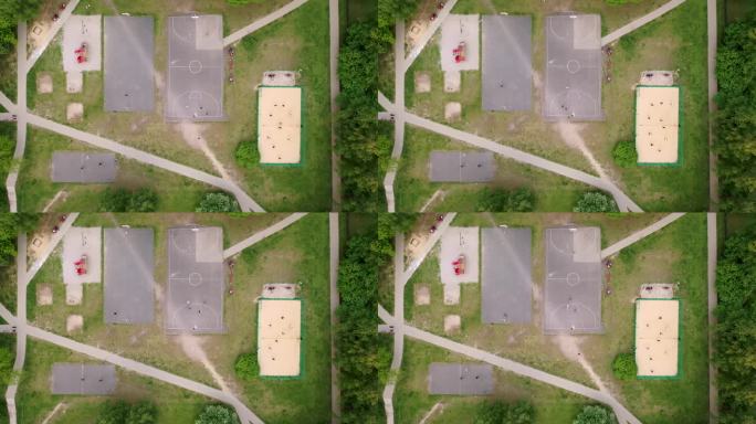 无人机拍摄的多个操场、篮球场、排球场和孩子们玩耍的画面，