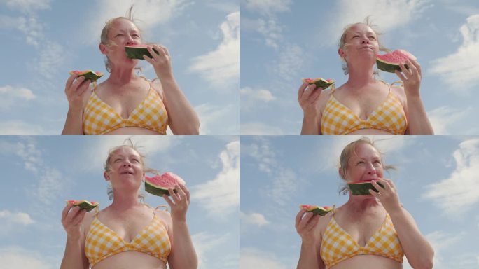 女人吃西瓜。海边野餐