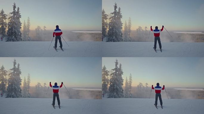 滑雪者克服了困难的路线，在山顶，举起双手表示胜利