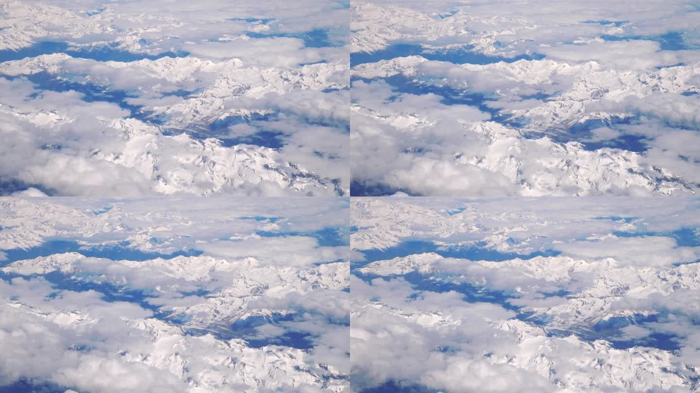 壮丽的鸟瞰图从飞机飞越惊人的山脉在4k慢动作60fps