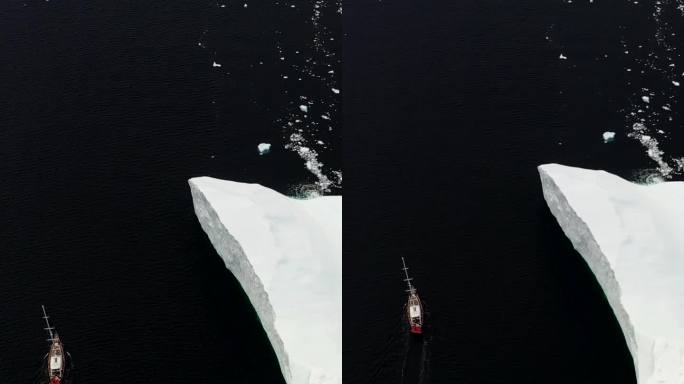 垂直视频以冰山为背景，轮船在南极洲航行。