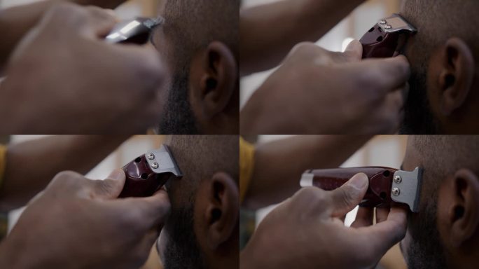 在理发店里，非裔美国人用剃须机剪现代发型的特写镜头