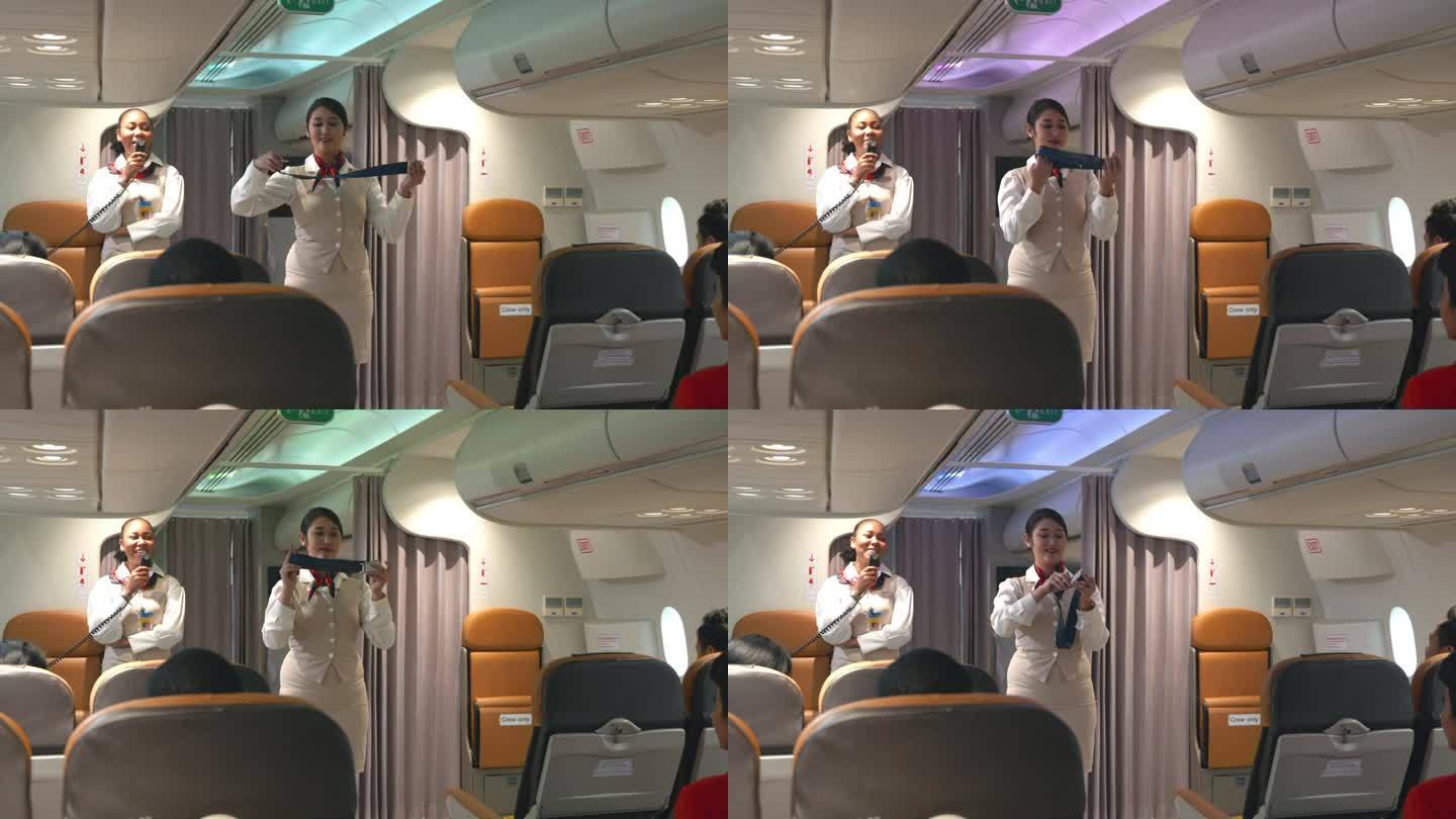 亚洲安全空姐向乘客讲解如何在飞机上使用安全带