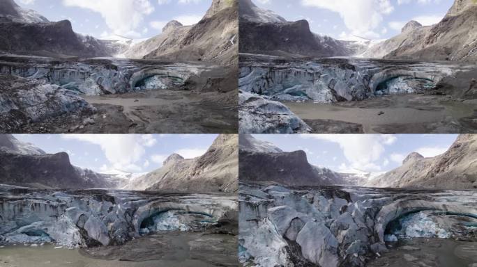 帕斯泰策冰川因气候变化而融化的冰洞全景，大格洛克纳山下部奥地利阿尔卑斯山脉的退缩冰川覆盖着碎片，航拍