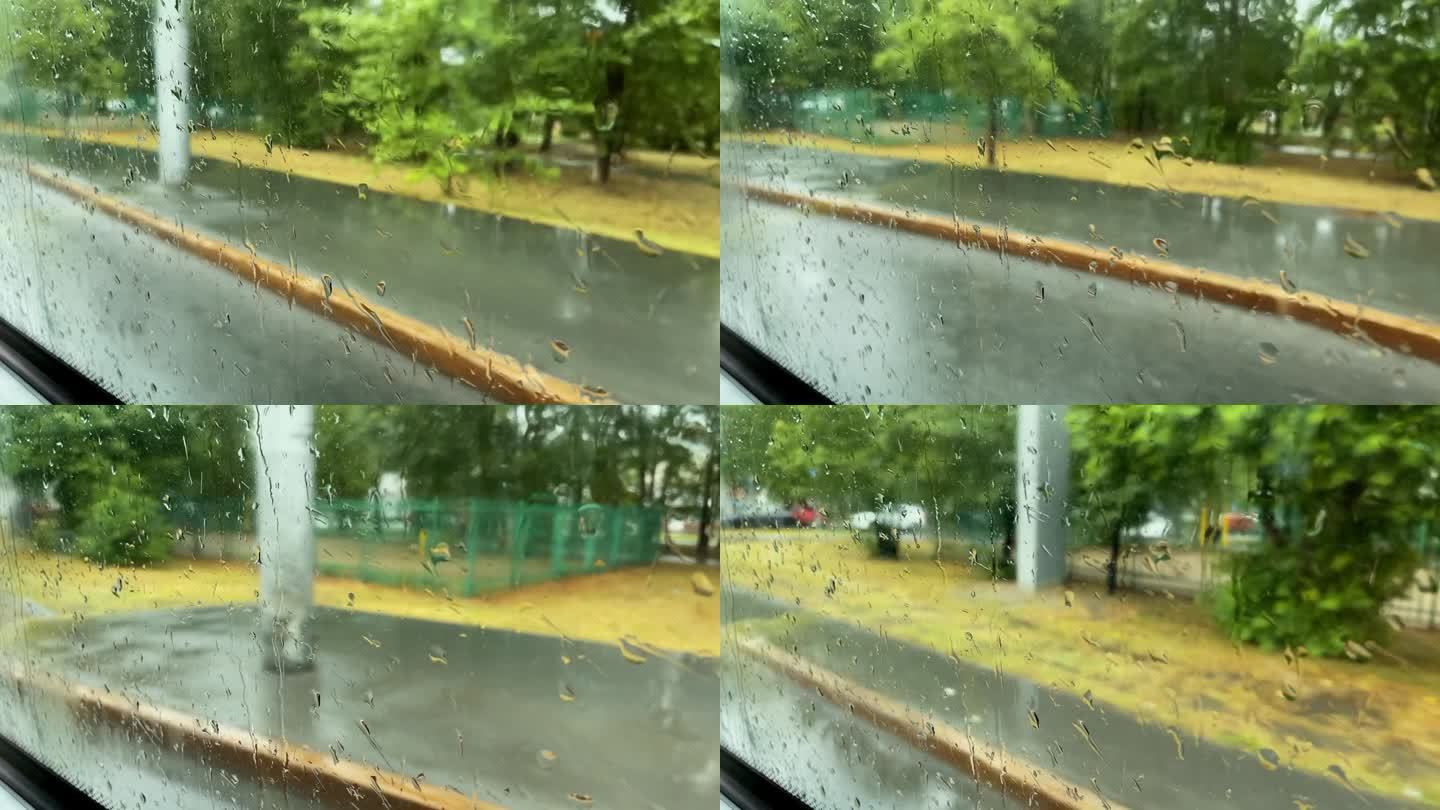 汽车西面玻璃窗的特写，雨点落在背景中。