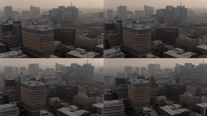 里士满空气质量差，污染严重。弗吉尼亚州里士满市区通勤道路和建筑物上方的烟雾。航拍镜头，向后移动，平移