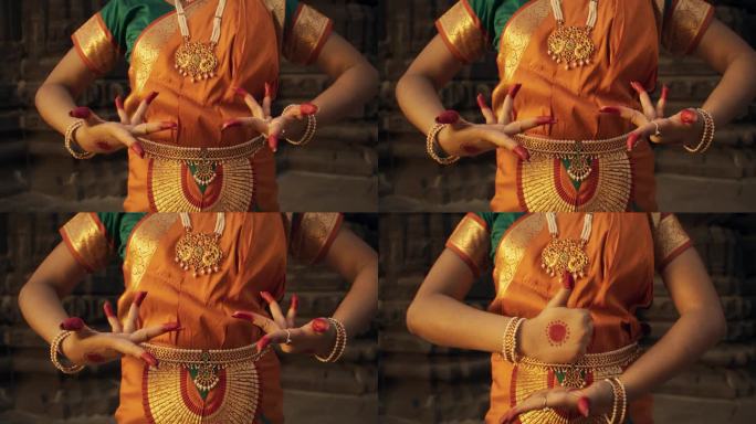 一个印度女舞者在民间舞蹈中做象征性手势传达不同信息的手的特写慢镜头。穿着传统纱丽的女孩展示不同的手印