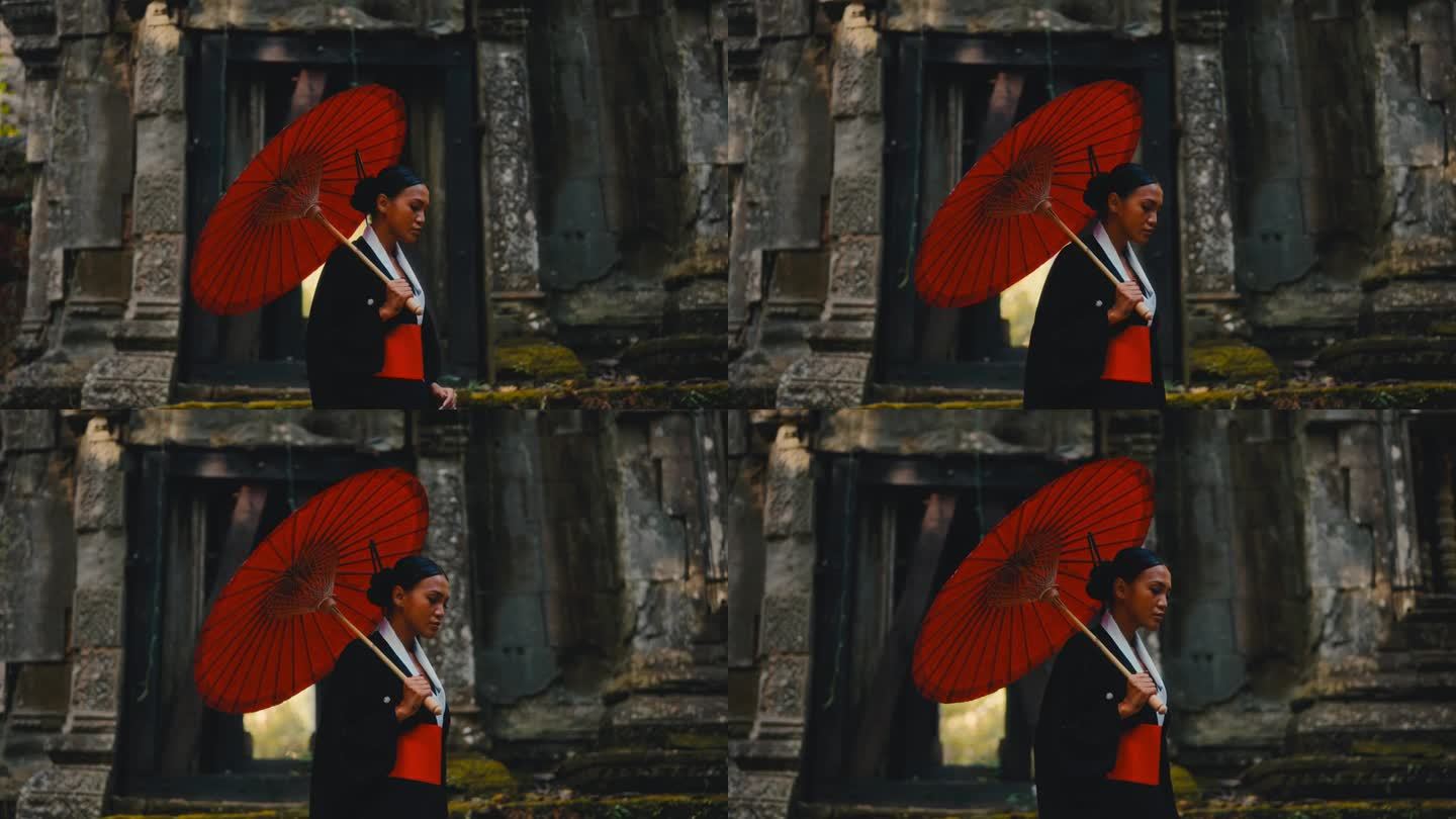 手持红伞的女子在庙里散步