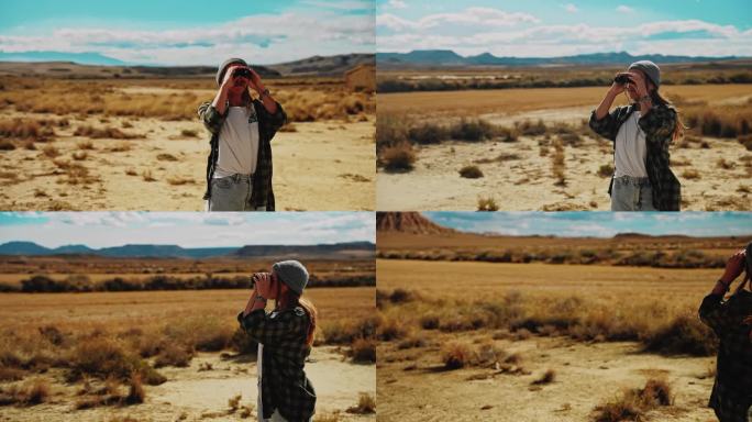 一名妇女用双筒望远镜观察摩洛哥的沙漠和落基山脉