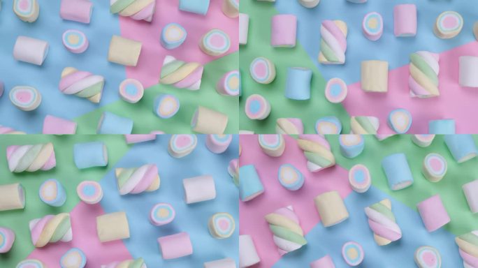五彩缤纷的背景上旋转五颜六色的耐嚼棉花糖，一个生日，节日，有趣的概念，时尚甜蜜的背景