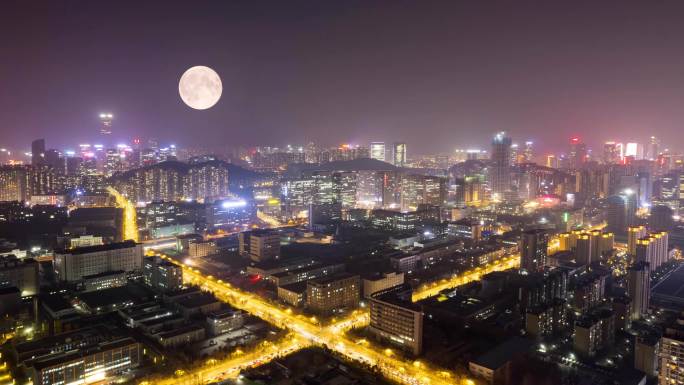 夜晚城市月亮慢慢升起圆月中秋月亮