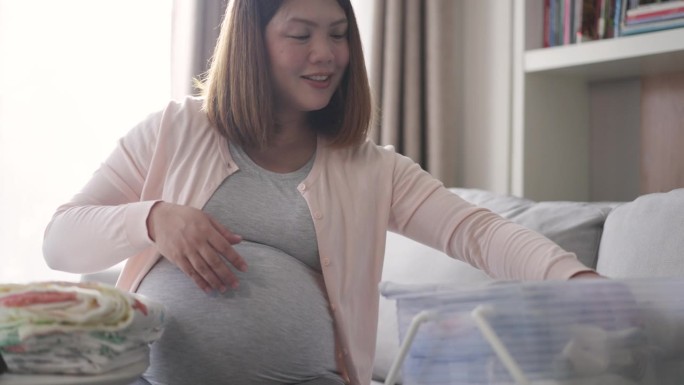 Pregnant woman packing bag for her baby