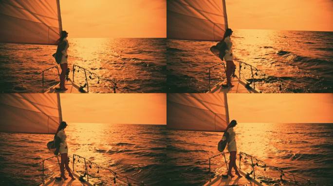 年轻女子站在帆船甲板上欣赏大海