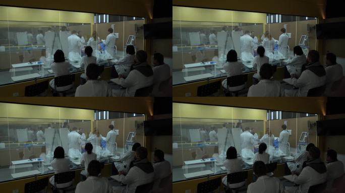 医学生在教室外透过玻璃窗做实践课的笔记