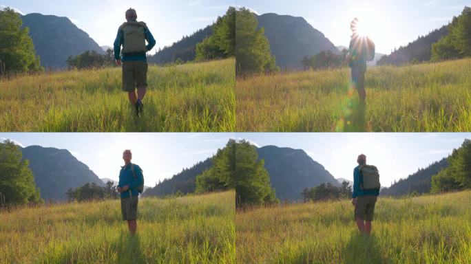资深男性徒步旅行者探索高山草地，用智能手机拍照