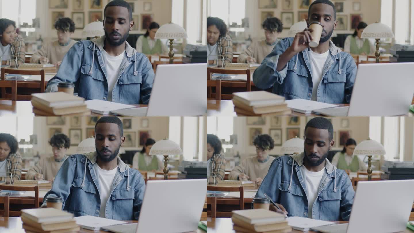 大学生，非裔美国人，在图书馆用笔记本电脑工作，喝着外带咖啡