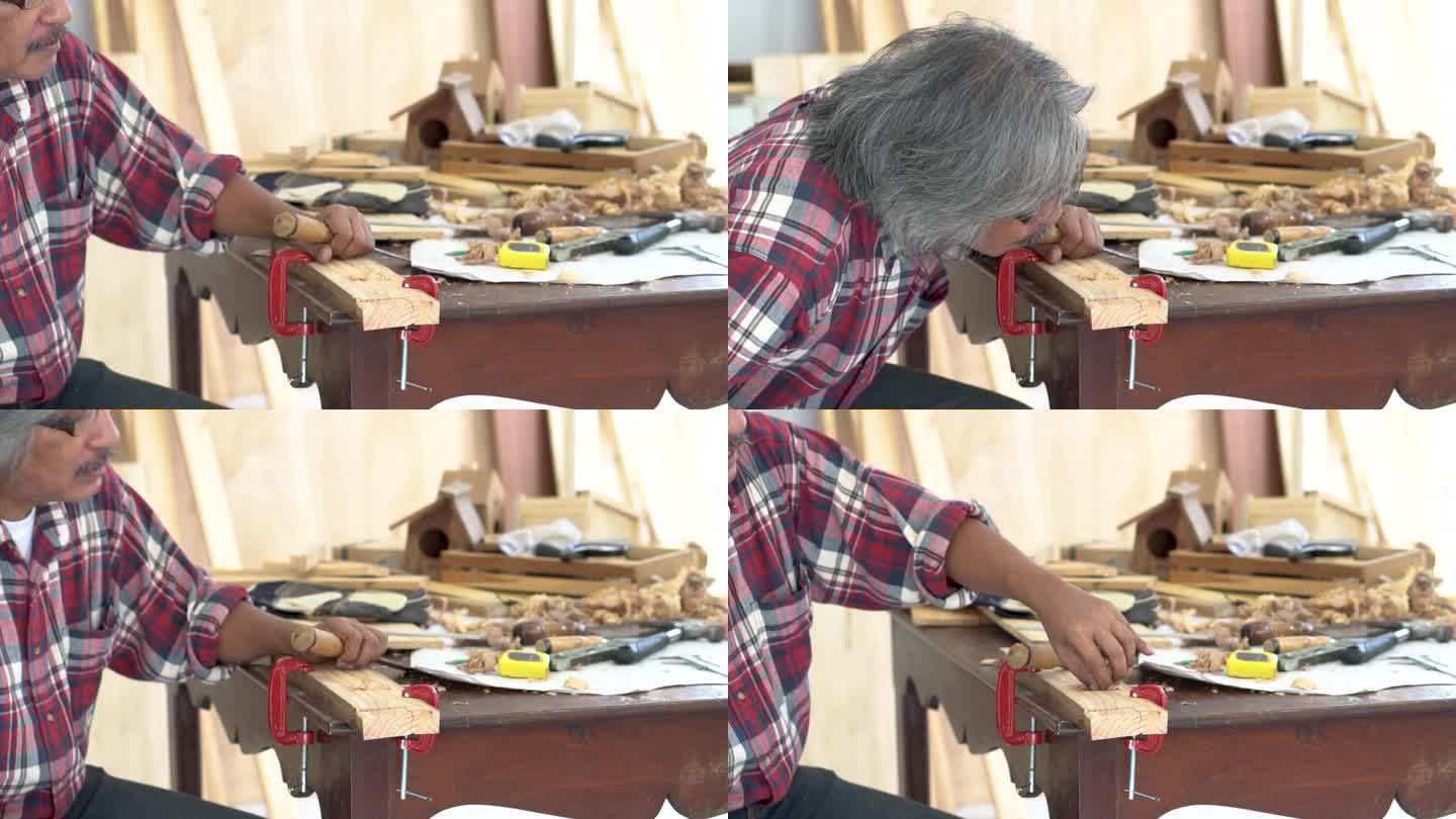 经验丰富的老木匠在木工店里专注于他的工作，银发的小企业主木工享受他的木箱，退休的老工匠在度假时在木桌