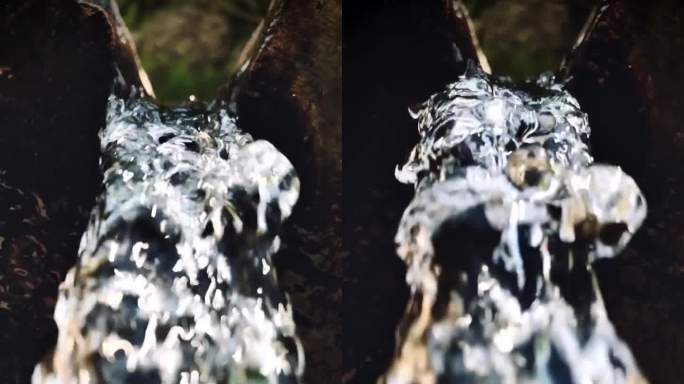 水流从一个天然的木管流向相机