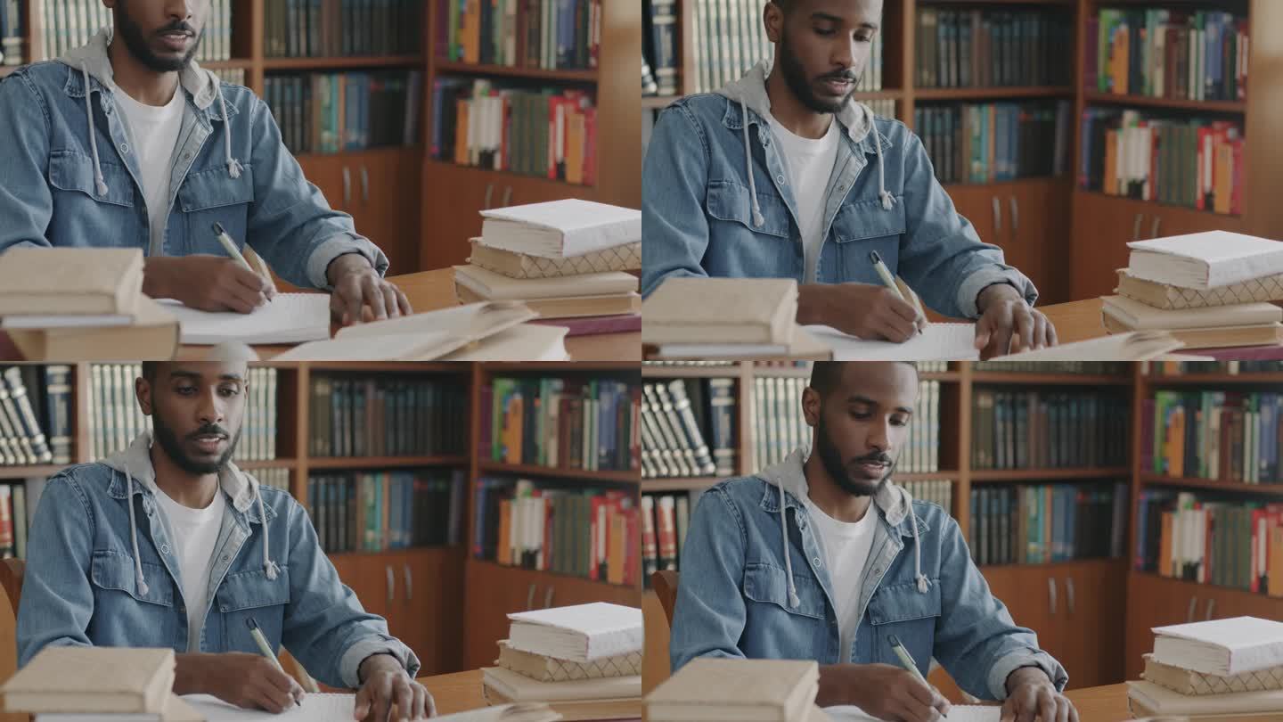 非裔美国人在笔记本上写信息，在图书馆学习书籍，获取知识