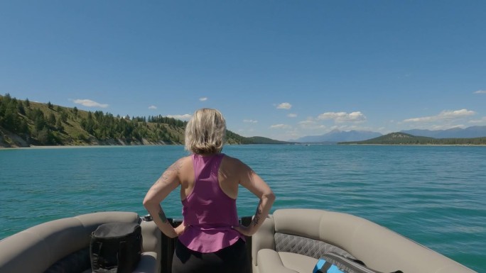 女子在船上放松，渡过湖面