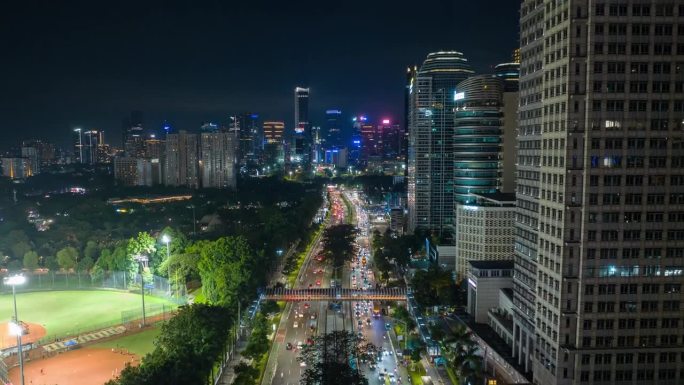 雅加达市夜间照明市中心交通街道道路工作体育场航拍全景4k延时印尼