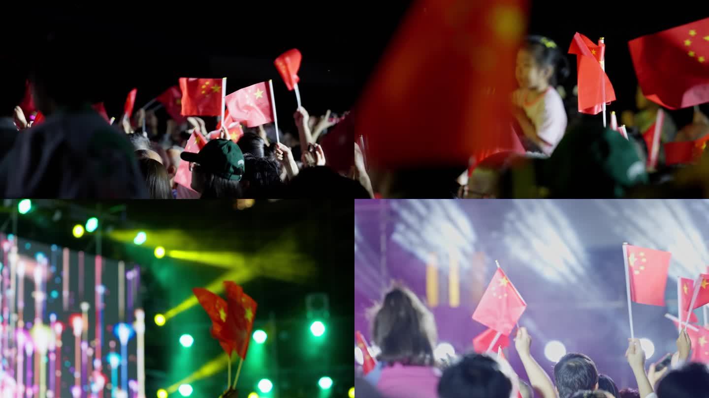 音乐节现场观众跟着节奏挥动手中的小红旗