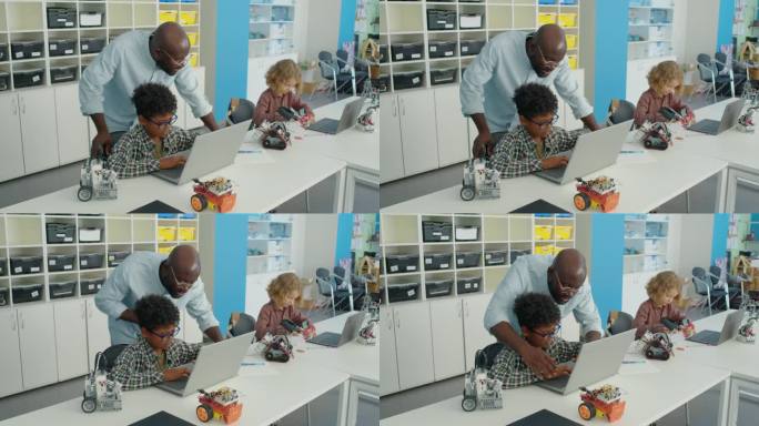 老师帮助青春期前的男孩编写电动机器人程序