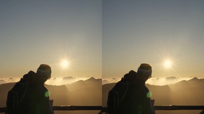一个人在山上看日落的垂直视频