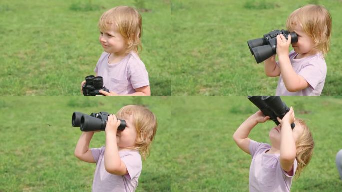 小女孩在森林里用双筒望远镜。2岁的孩子展望未来。带着望远镜微笑的婴儿。冒险、想象、旅行理念。自由,假