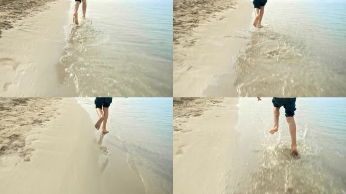 孩子的脚在沙滩上奔跑的特写，平静的海浪中溅起了水。假期，假期，周末在大自然