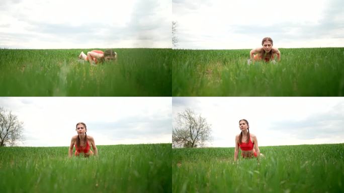 穿着橙色衣服的运动女子在新鲜的绿色田野里做瑜伽。复杂的体式——卧倒、平衡、禅。健身，天天练自然，健康
