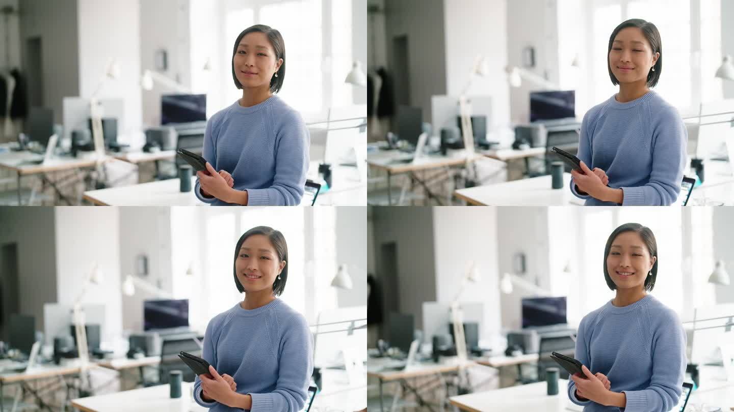 一个快乐的专业女性手持数码平板电脑的肖像