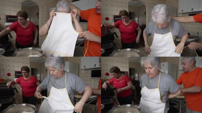资深女士系上围裙准备做午饭。一位白发苍苍的白种老妇人正在准备烹饪