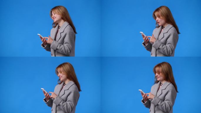 一个女孩用手机的4k视频，蓝色背景。