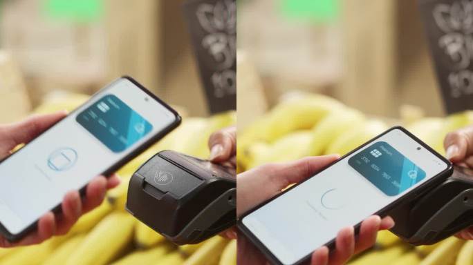 垂直屏幕:客户使用带有信用卡银行NFC应用程序的智能手机进行安全的Swift非接触式支付。现代购物者