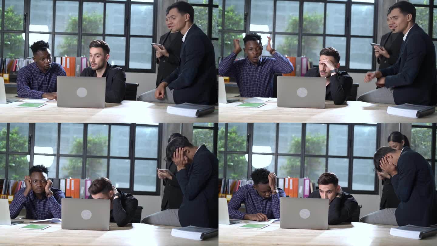 一群失望的多民族商人在办公室用笔记本电脑表达消极情绪。多元化团队建设年轻员工受挫压力，失败和疲惫在一