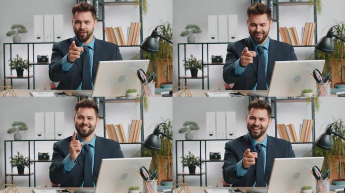 一个在办公室笔记本电脑前工作的商人，带着快乐的表情指着相机，做出了选择