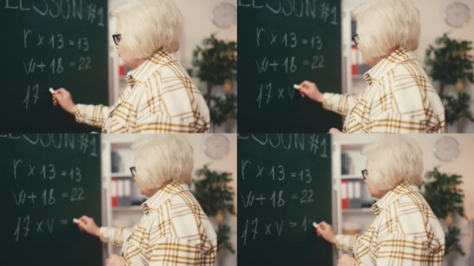 高级女数学老师在黑板上写方程式，在教一课