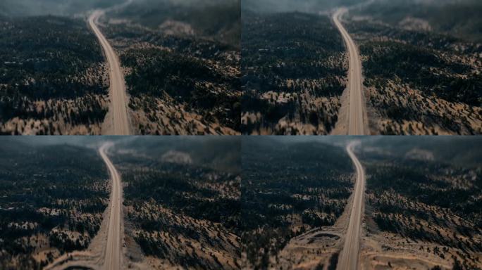 蜿蜒的道路在绿色的森林在山上。无人机航拍图