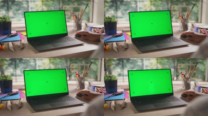 匿名非洲设计师在笔记本电脑上工作，模拟绿色屏幕Chromakey显示与孤立的占位符。用于艺术内容创作