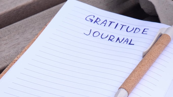 在木凳上写感恩日记。今天我心存感激。自我发现日志，自我反思创意写作，自我成长个人发展理念。幸福精神健